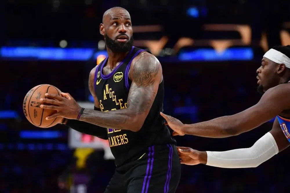 May 11, 2026; Los Angeles, California, USA; Los Angeles Lakers forward LeBron James (23) controls the ball against Oklahoma City Thunder guard Luguentz Dort (5) during the first half in game four of the second round of the 2026 NBA Playoffs at Crypto.com Arena. Mandatory Credit: Gary A. Vasquez-Imagn Images